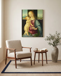 Madonna with a Pomegranate by Lorenzo di Credi as a stretched canvas above a linen lounge chair in a reading corner