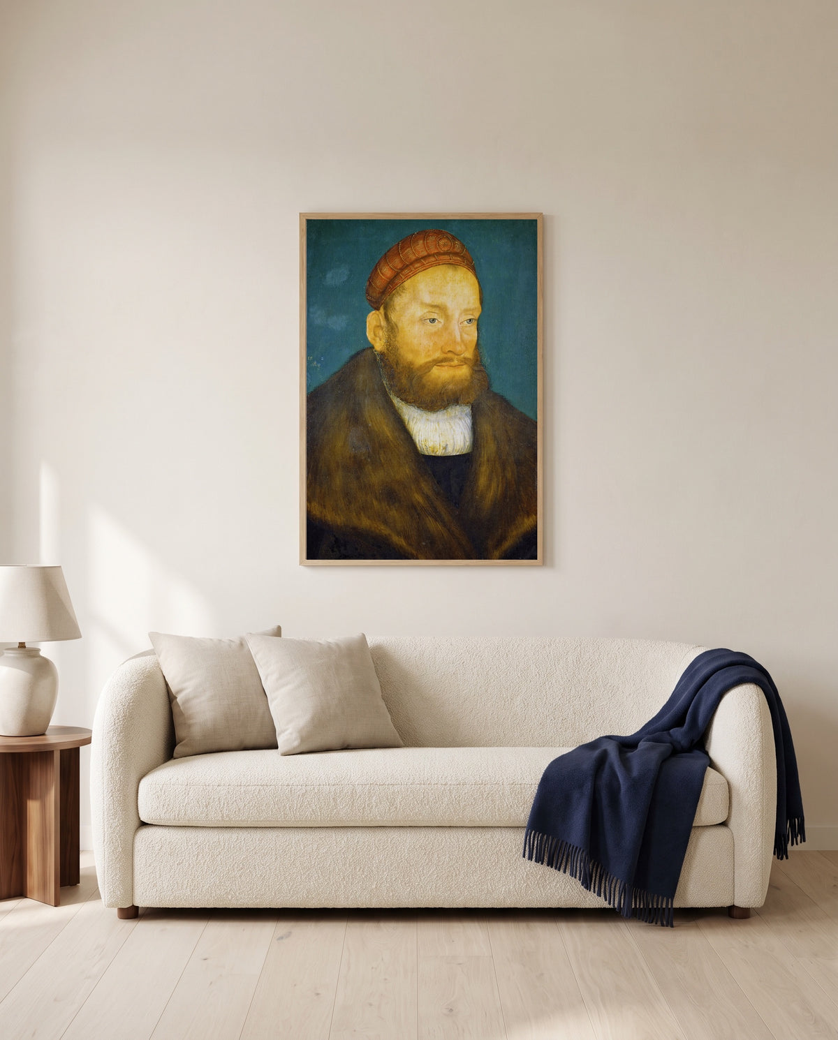 Margrave Casimir by Lucas Cranach the Elder framed in natural oak above a cream sofa in a warm living room