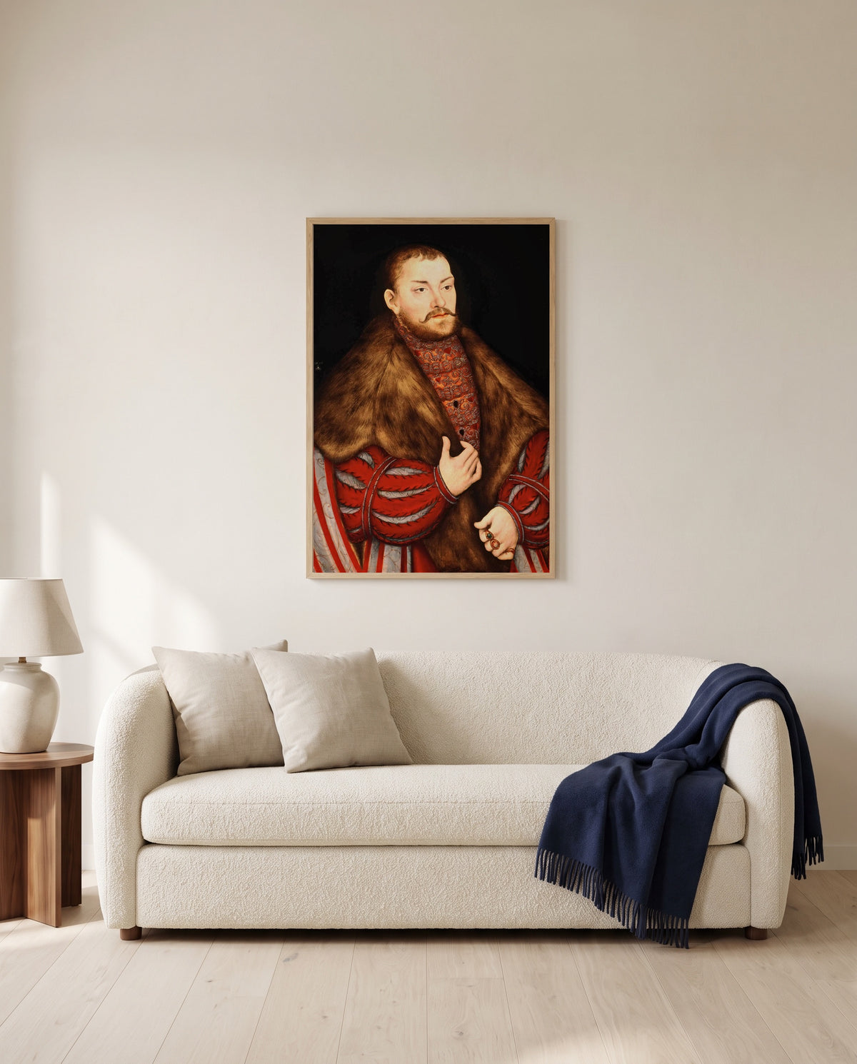 Portrait of Joachim II by Lucas Cranach the Elder framed in natural oak above a cream sofa in a warm living room