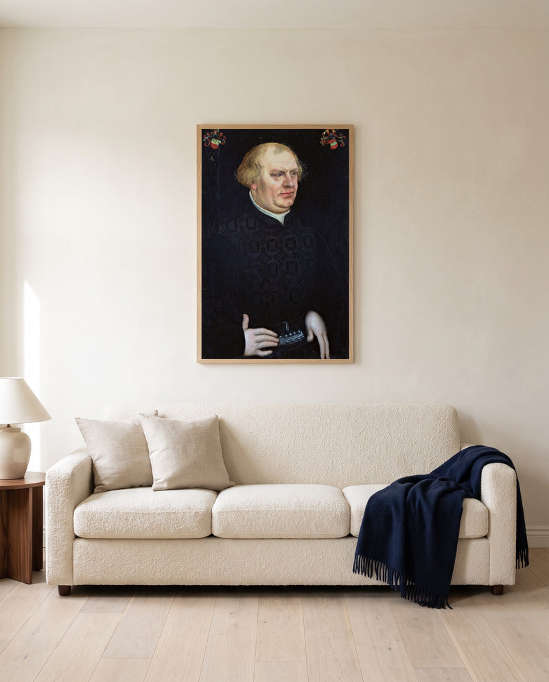 Portrait of Johann Feige by Lucas Cranach the Elder framed in natural oak above a cream sofa in a warm living room