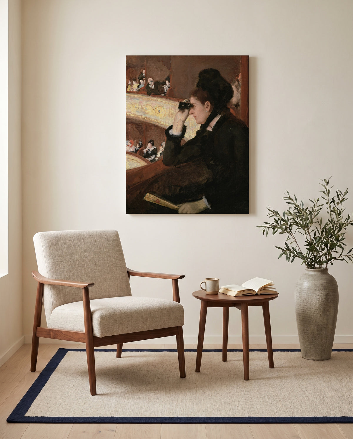 In the Loge by Mary Cassatt as a stretched canvas above a linen lounge chair in a reading corner