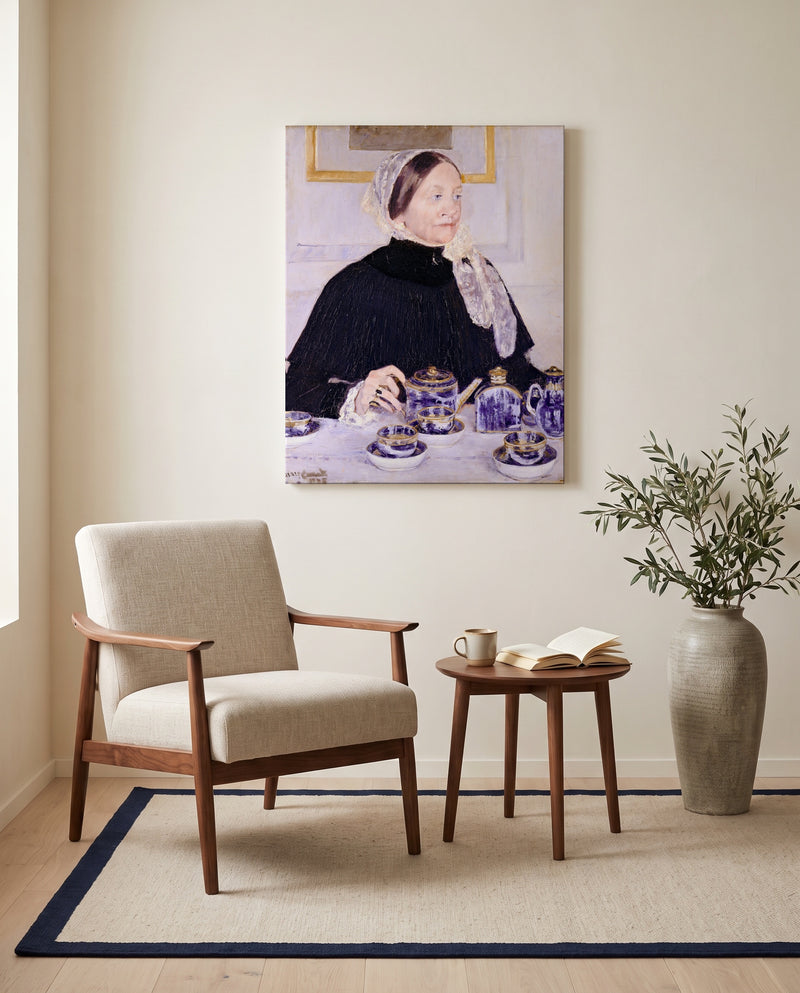 Lady at the Tea Table by Mary Cassatt as a stretched canvas above a linen lounge chair in a reading corner
