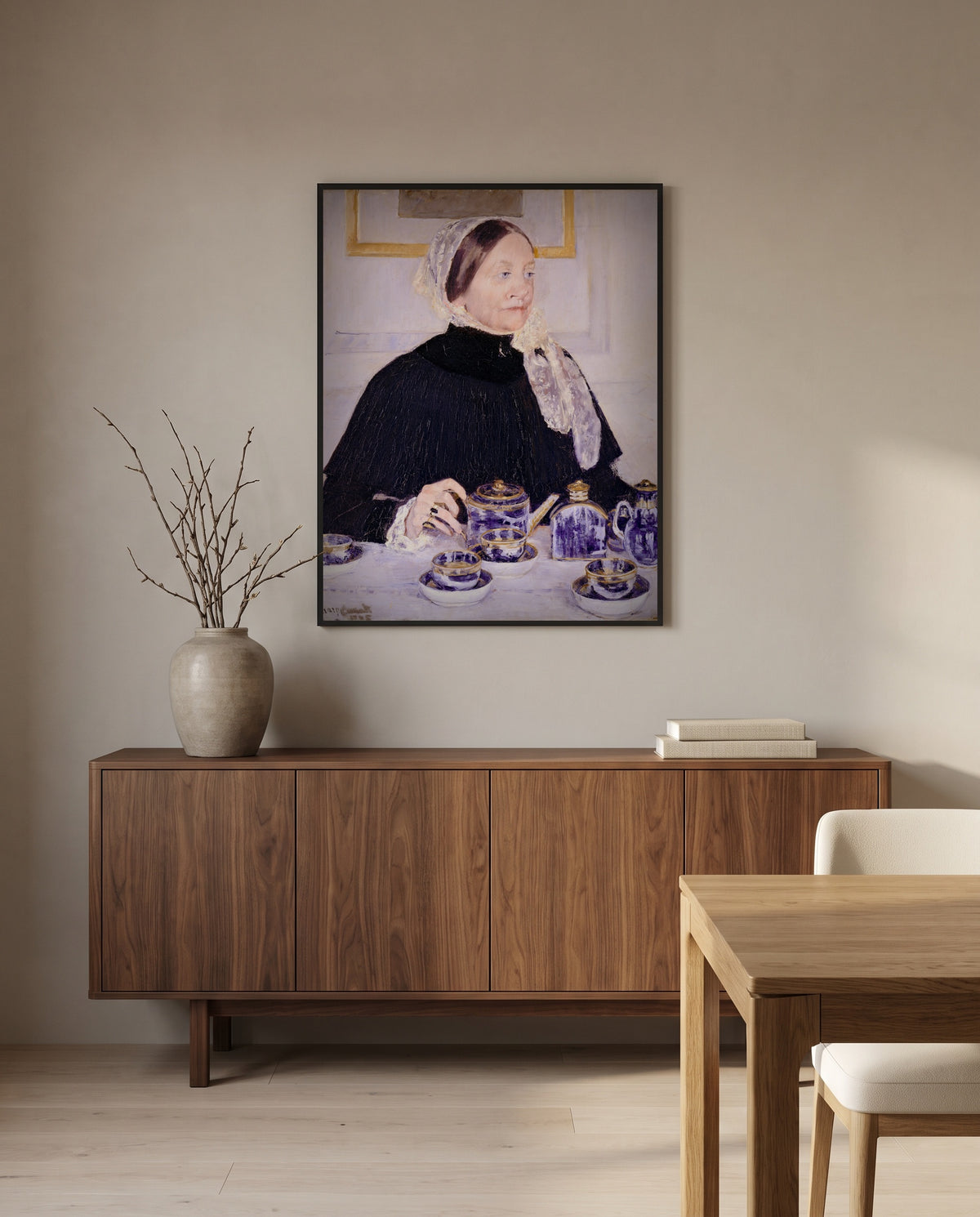 Lady at the Tea Table by Mary Cassatt in a black frame above a walnut sideboard in a dining room