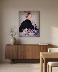 Lady at the Tea Table by Mary Cassatt in a black frame above a walnut sideboard in a dining room