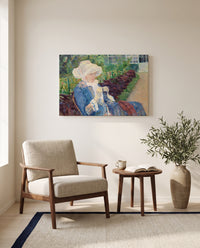 Lydia Crocheting by Mary Cassatt as a stretched canvas above a linen lounge chair in a reading corner