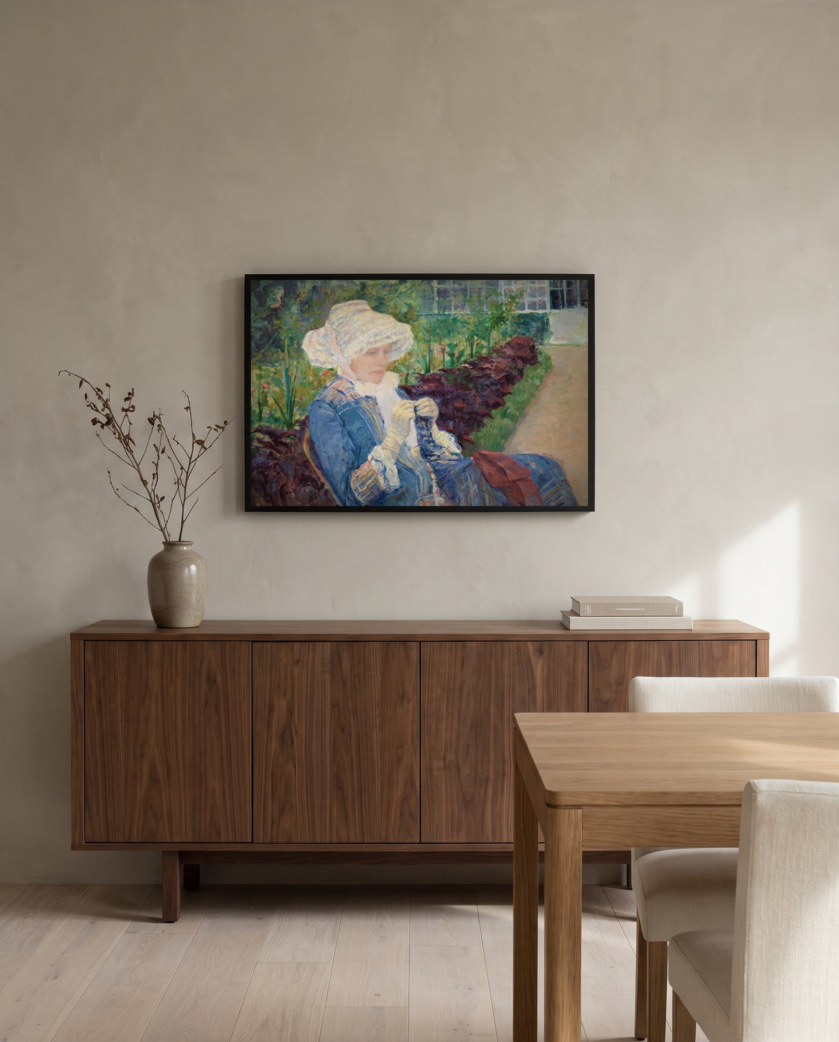 Lydia Crocheting by Mary Cassatt in a black frame above a walnut sideboard in a dining room