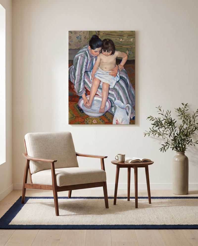 The Child’s Bath by Mary Cassatt as a stretched canvas above a linen lounge chair in a reading corner