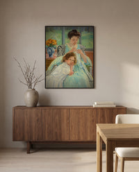 Young Mother Sewing by Mary Cassatt in a black frame above a walnut sideboard in a dining room