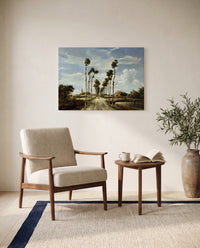 The Avenue at Middelharnis by Meindert Hobbema as a stretched canvas above a linen lounge chair in a reading corner