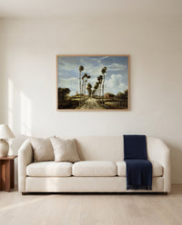 The Avenue at Middelharnis by Meindert Hobbema framed in natural oak above a cream sofa in a warm living room