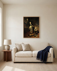The Idle Servant by Nicolaes Maes framed in natural oak above a cream sofa in a warm living room
