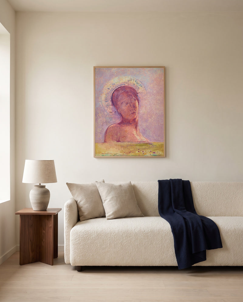 In Heaven by Odilon Redon framed in natural oak above a cream sofa in a warm living room