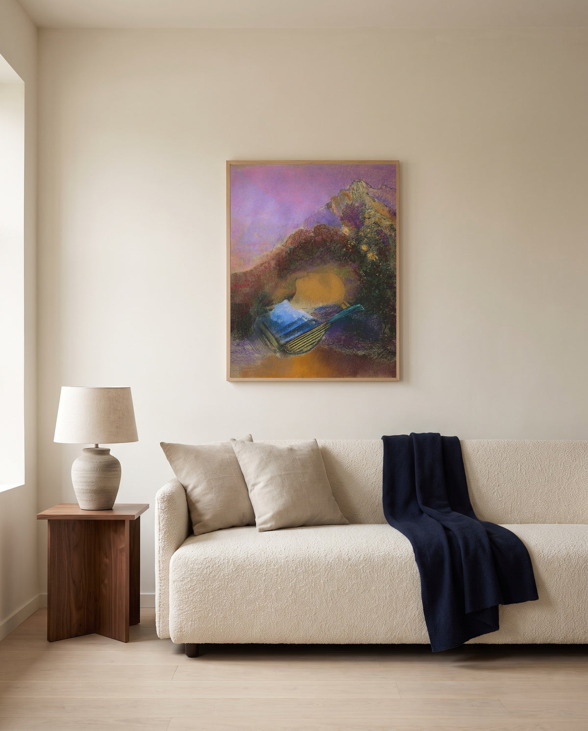 Orpheus by Odilon Redon framed in natural oak above a cream sofa in a warm living room