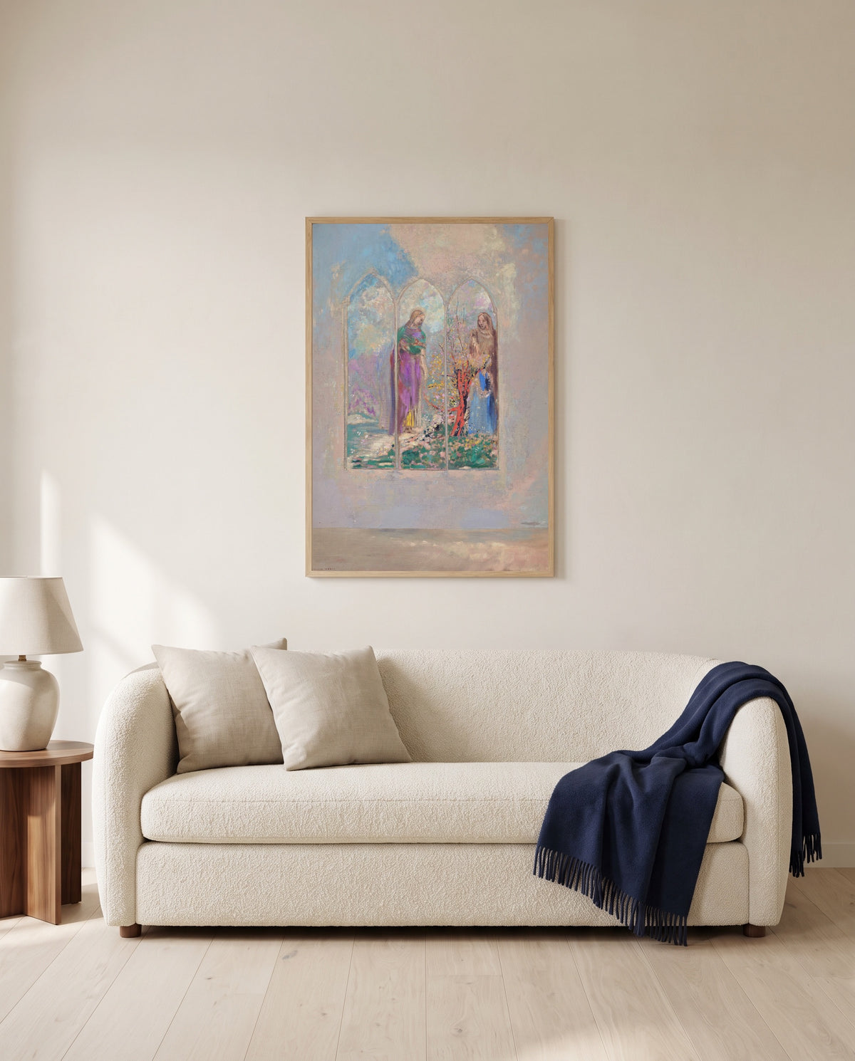 Piety beside a Red Tree by Odilon Redon framed in natural oak above a cream sofa in a warm living room
