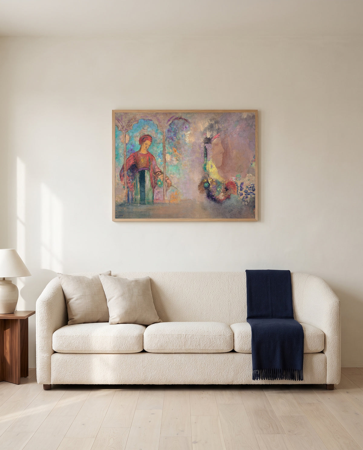Woman in a Gothic Arcade by Odilon Redon framed in natural oak above a cream sofa in a warm living room