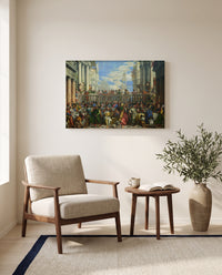 The Wedding at Cana by Paolo Veronese as a stretched canvas above a linen lounge chair in a reading corner