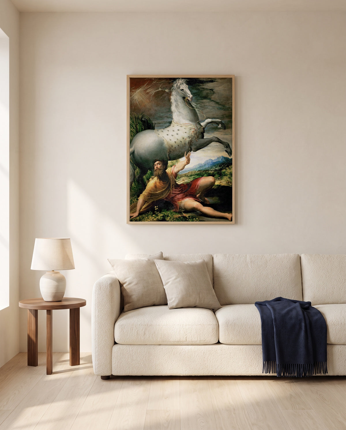 Conversion of Saint Paul by Parmigianino framed in natural oak above a cream sofa in a warm living room