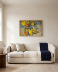 Apples by Paul Cézanne framed in natural oak above a cream sofa in a warm living room