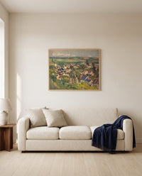 Auvers, Panoramic View by Paul Cézanne framed in natural oak above a cream sofa in a warm living room