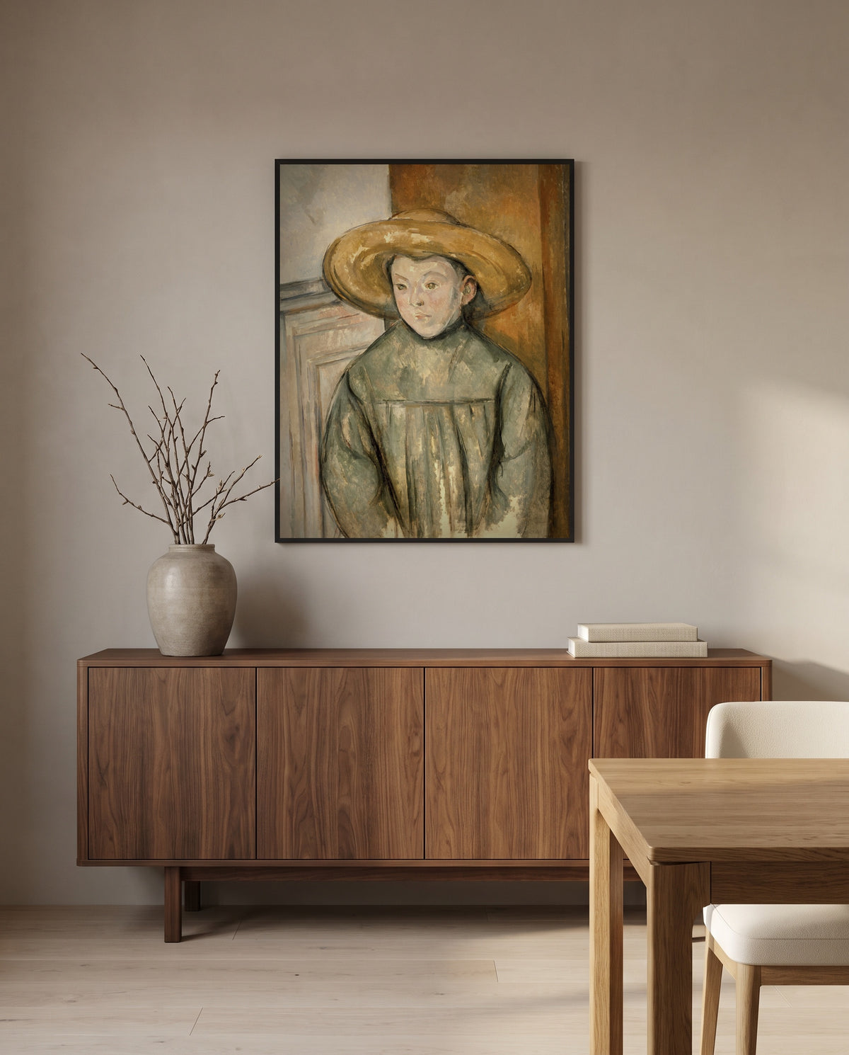 Boy with a Straw Hat by Paul Cézanne in a black frame above a walnut sideboard in a dining room