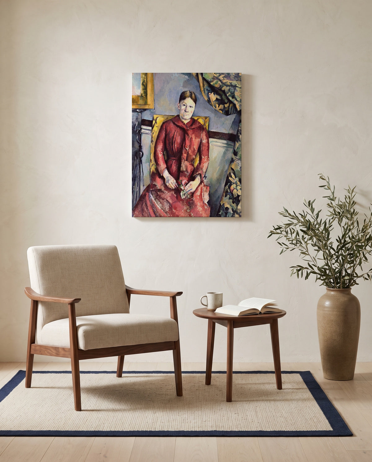 Madame Cézanne in Red by Paul Cézanne as a stretched canvas above a linen lounge chair in a reading corner