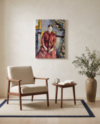 Madame Cézanne in Red by Paul Cézanne as a stretched canvas above a linen lounge chair in a reading corner