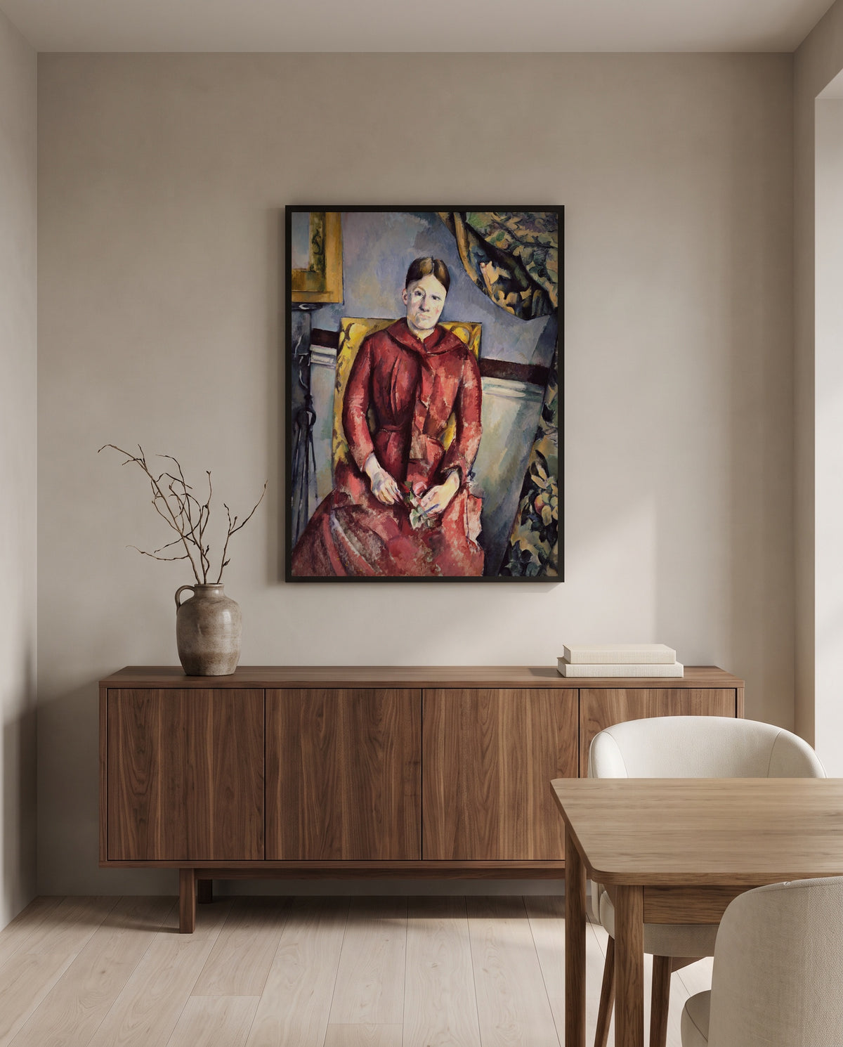 Madame Cézanne in Red by Paul Cézanne in a black frame above a walnut sideboard in a dining room