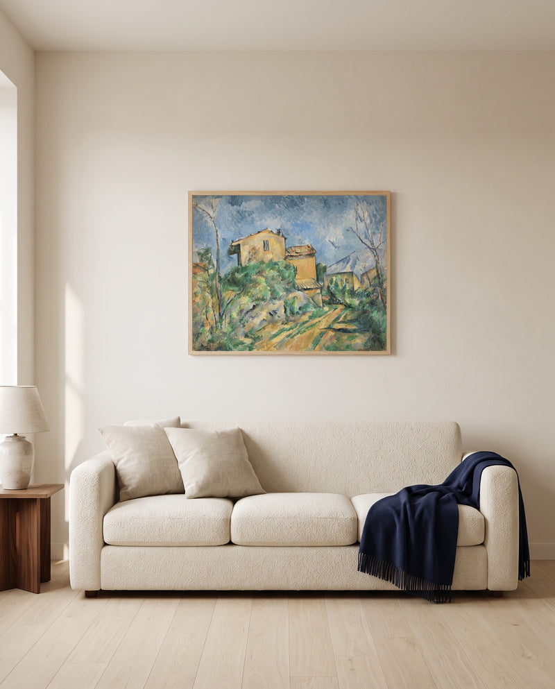 Maison Maria by Paul Cézanne framed in natural oak above a cream sofa in a warm living room