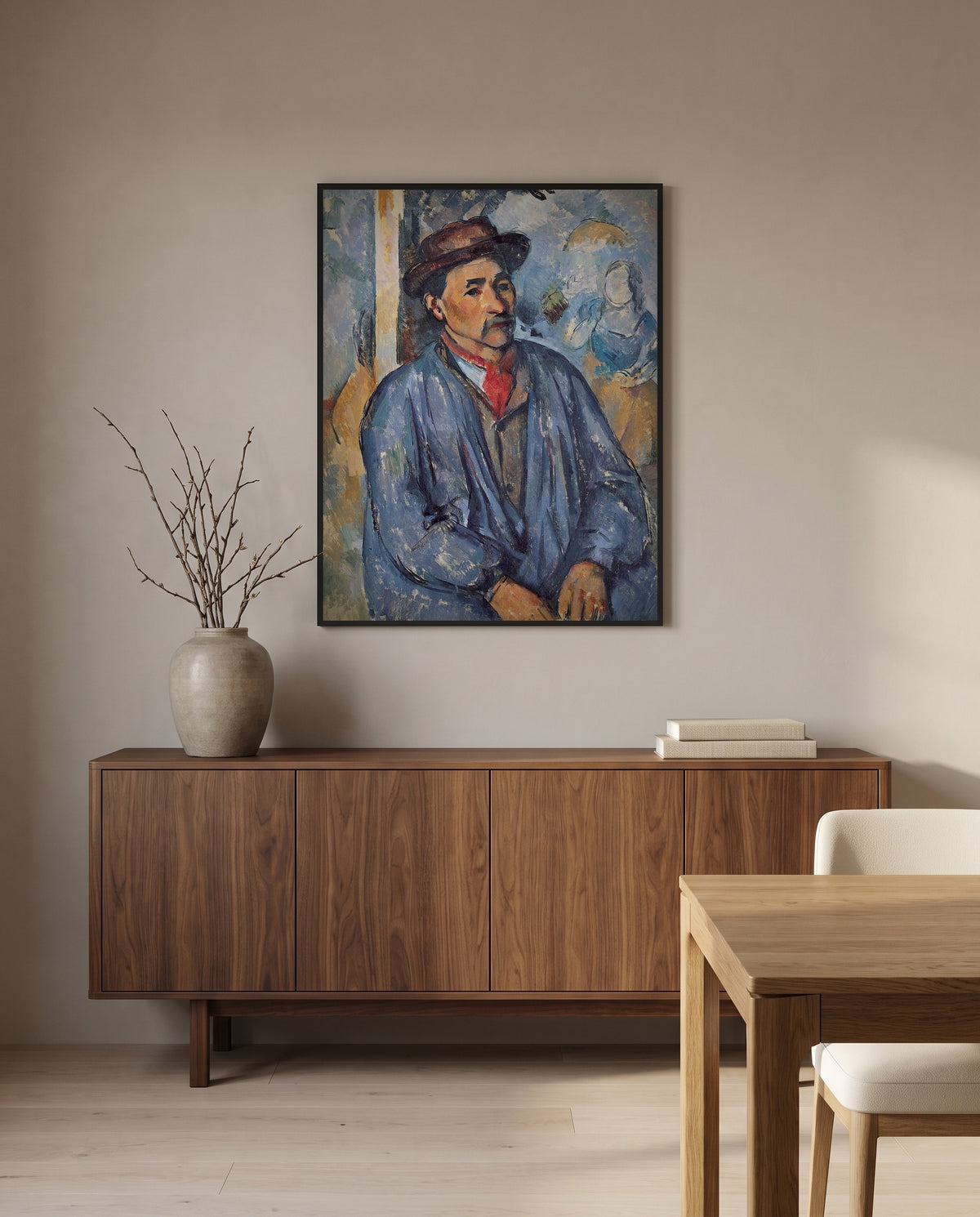 Man in a Blue Smock by Paul Cézanne in a black frame above a walnut sideboard in a dining room