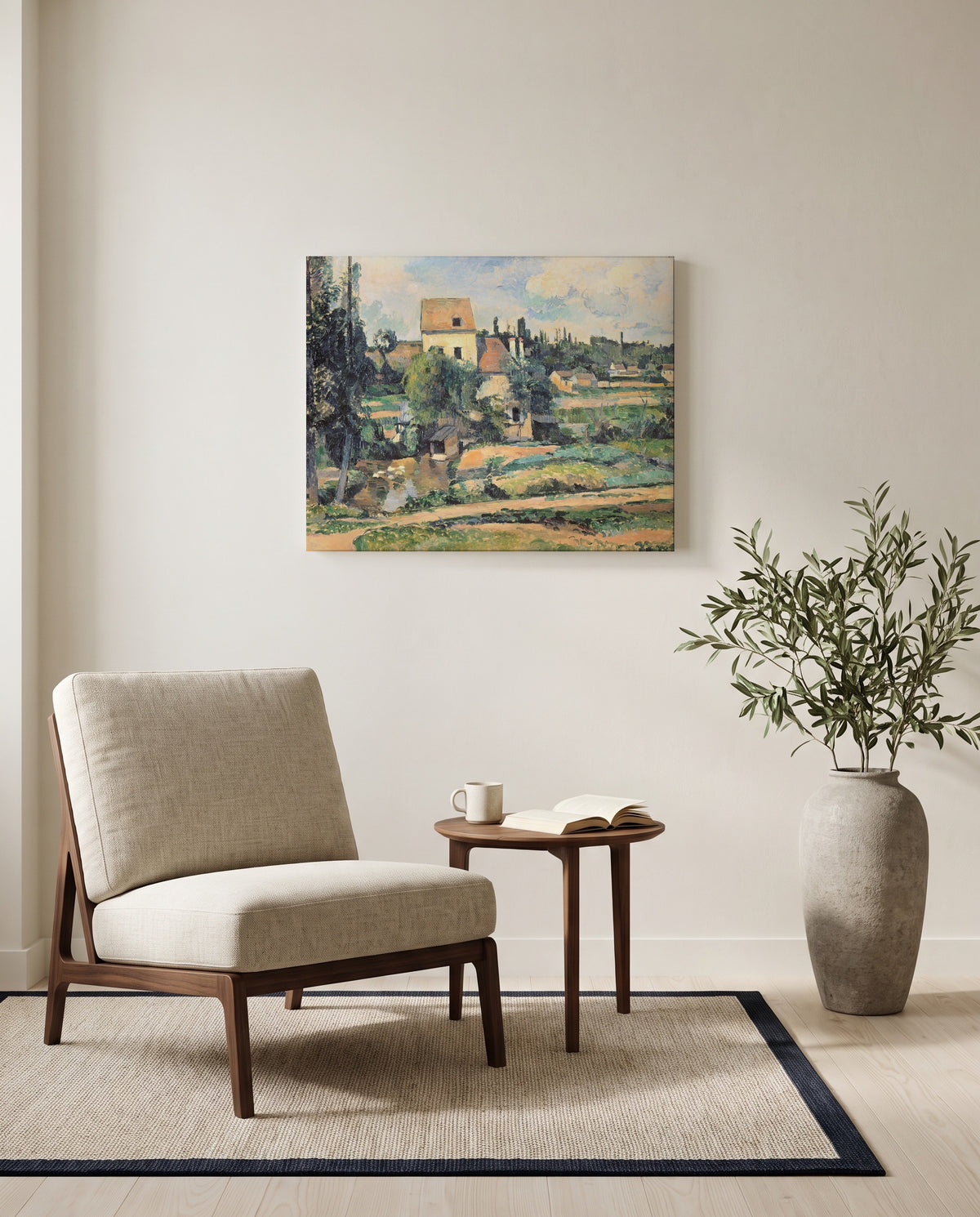 Mill at Pontoise by Paul Cézanne as a stretched canvas above a linen lounge chair in a reading corner