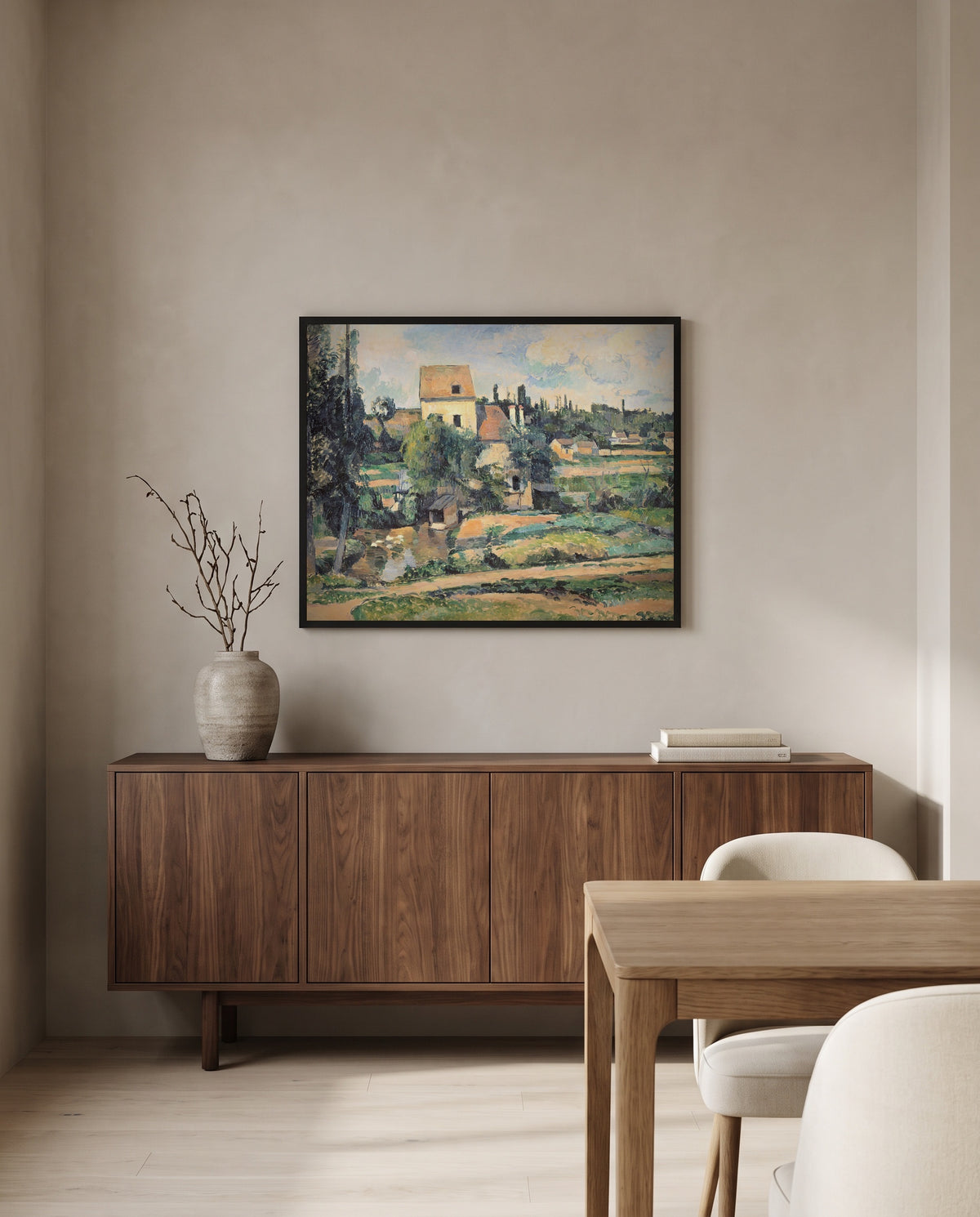 Mill at Pontoise by Paul Cézanne in a black frame above a walnut sideboard in a dining room