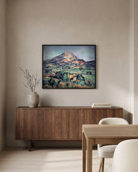 Sainte-Victoire from Bellevue by Paul Cézanne in a black frame above a walnut sideboard in a dining room