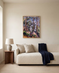 Pines and Rocks by Paul Cézanne framed in natural oak above a cream sofa in a warm living room