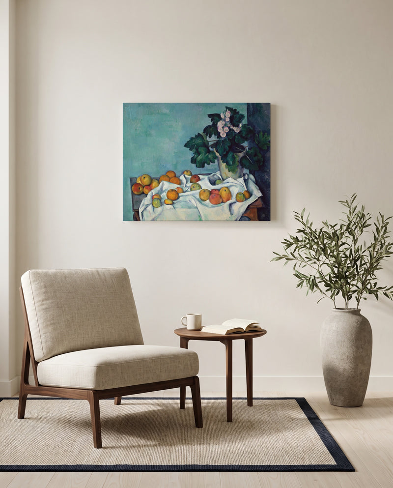 Apples and Primroses by Paul Cézanne as a stretched canvas above a linen lounge chair in a reading corner