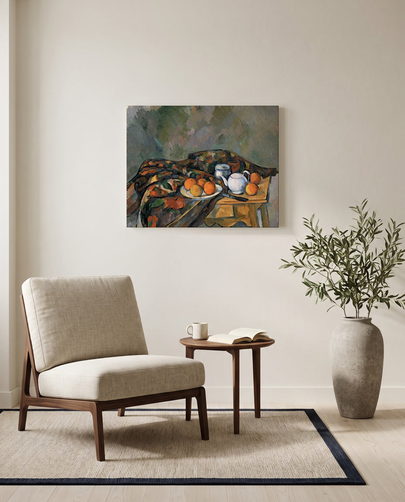 Still Life with Teapot by Paul Cézanne as a stretched canvas above a linen lounge chair in a reading corner