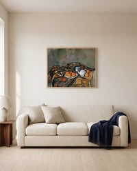 Still Life with Teapot by Paul Cézanne framed in natural oak above a cream sofa in a warm living room