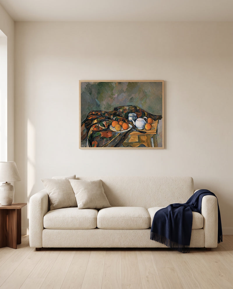 Still Life with Teapot by Paul Cézanne framed in natural oak above a cream sofa in a warm living room
