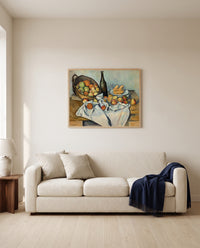 The Basket of Apples by Paul Cézanne framed in natural oak above a cream sofa in a warm living room