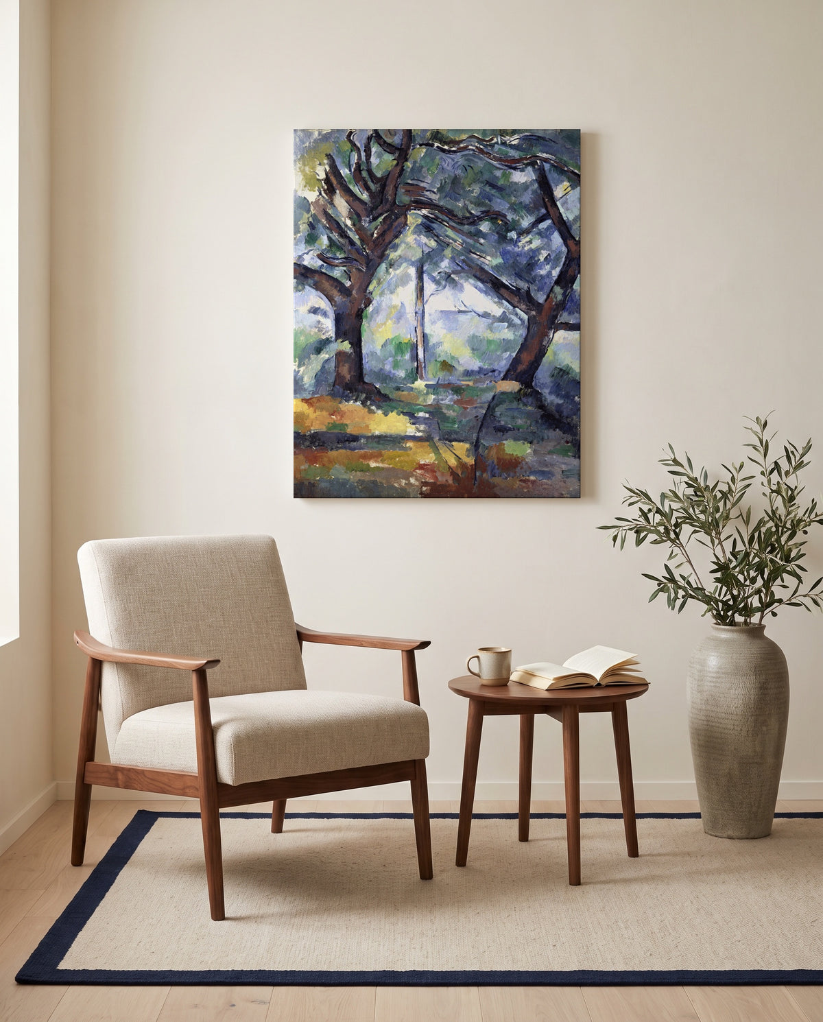 The Big Trees by Paul Cézanne as a stretched canvas above a linen lounge chair in a reading corner