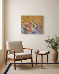 The Plate of Apples by Paul Cézanne as a stretched canvas above a linen lounge chair in a reading corner