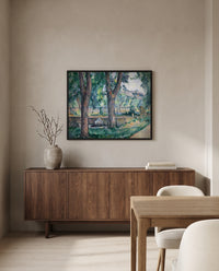 Pool at Jas de Bouffan by Paul Cézanne in a black frame above a walnut sideboard in a dining room