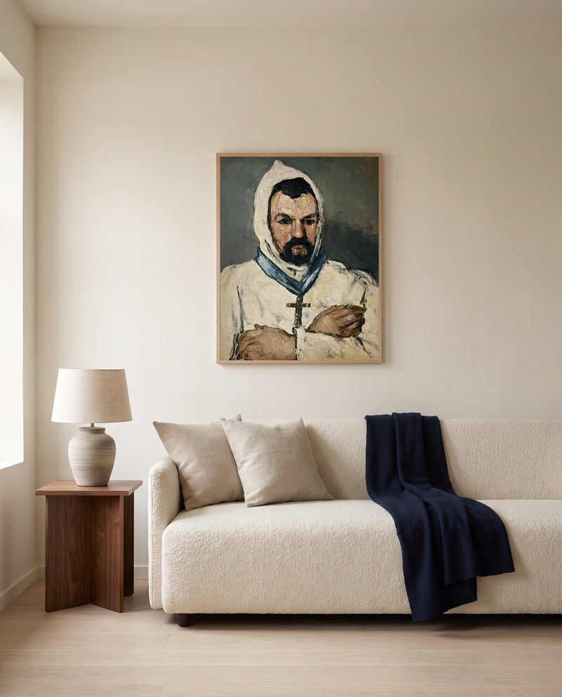 Uncle Dominique as a Monk by Paul Cézanne framed in natural oak above a cream sofa in a warm living room