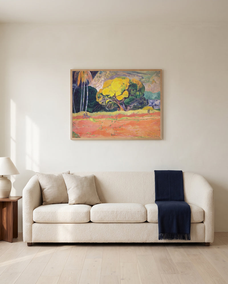 Fatata te Moua by Paul Gauguin framed in natural oak above a cream sofa in a warm living room