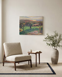 Fields by the Sea by Paul Gauguin as a stretched canvas above a linen lounge chair in a reading corner