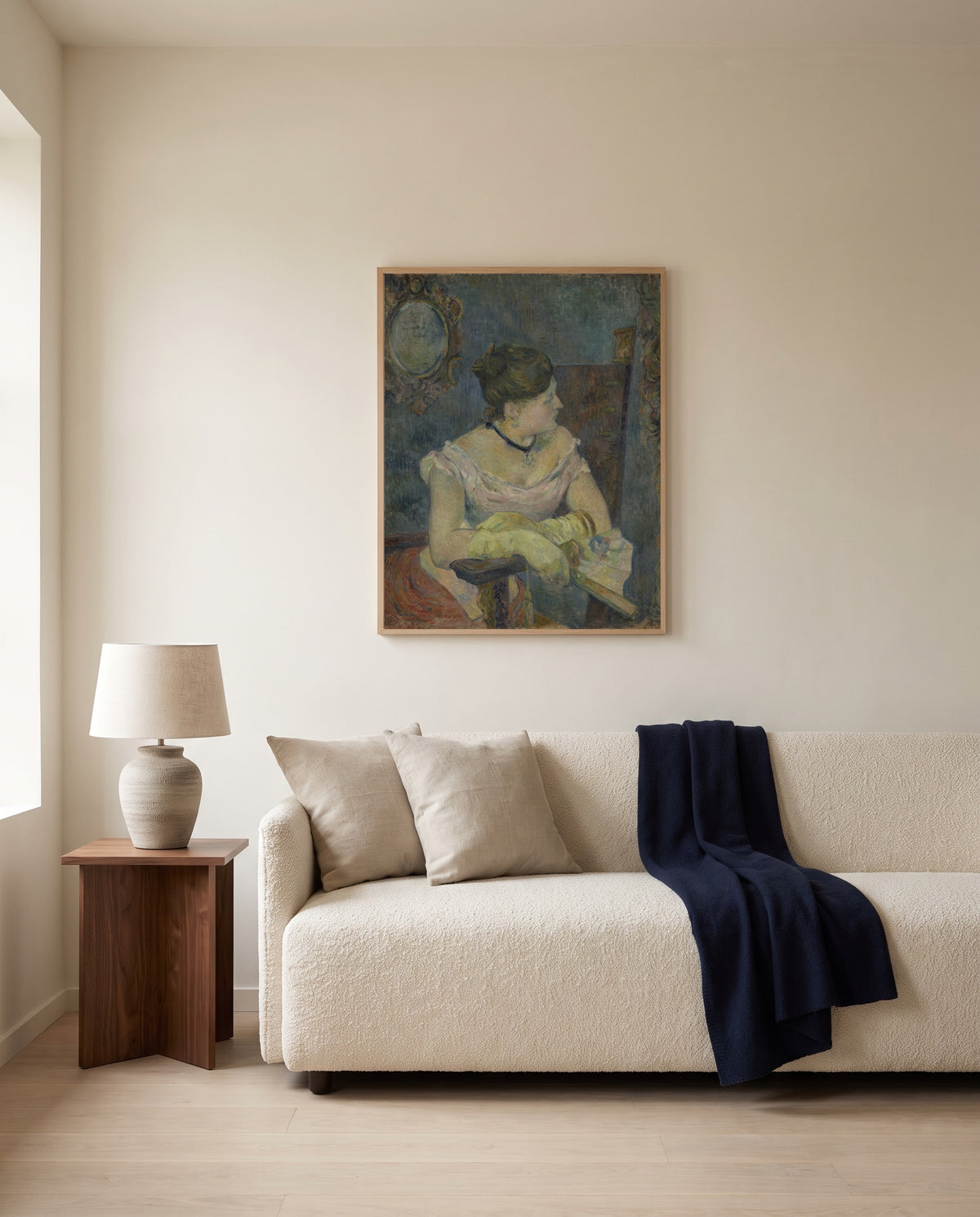 Mette Gauguin by Paul Gauguin framed in natural oak above a cream sofa in a warm living room