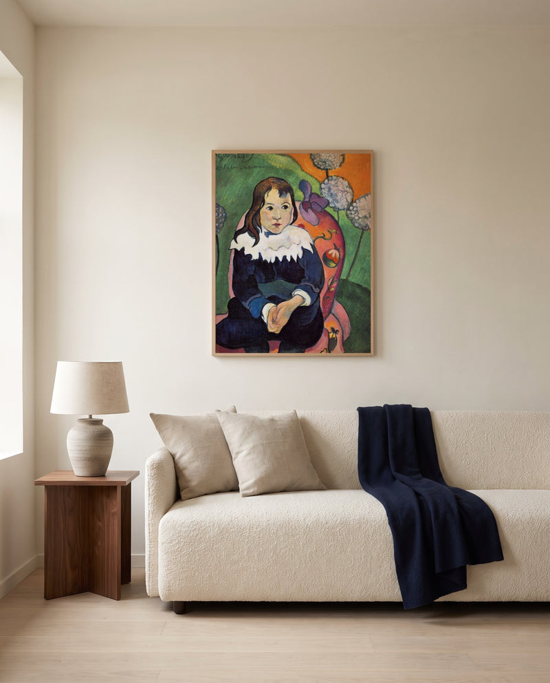 Mr. Loulou by Paul Gauguin framed in natural oak above a cream sofa in a warm living room