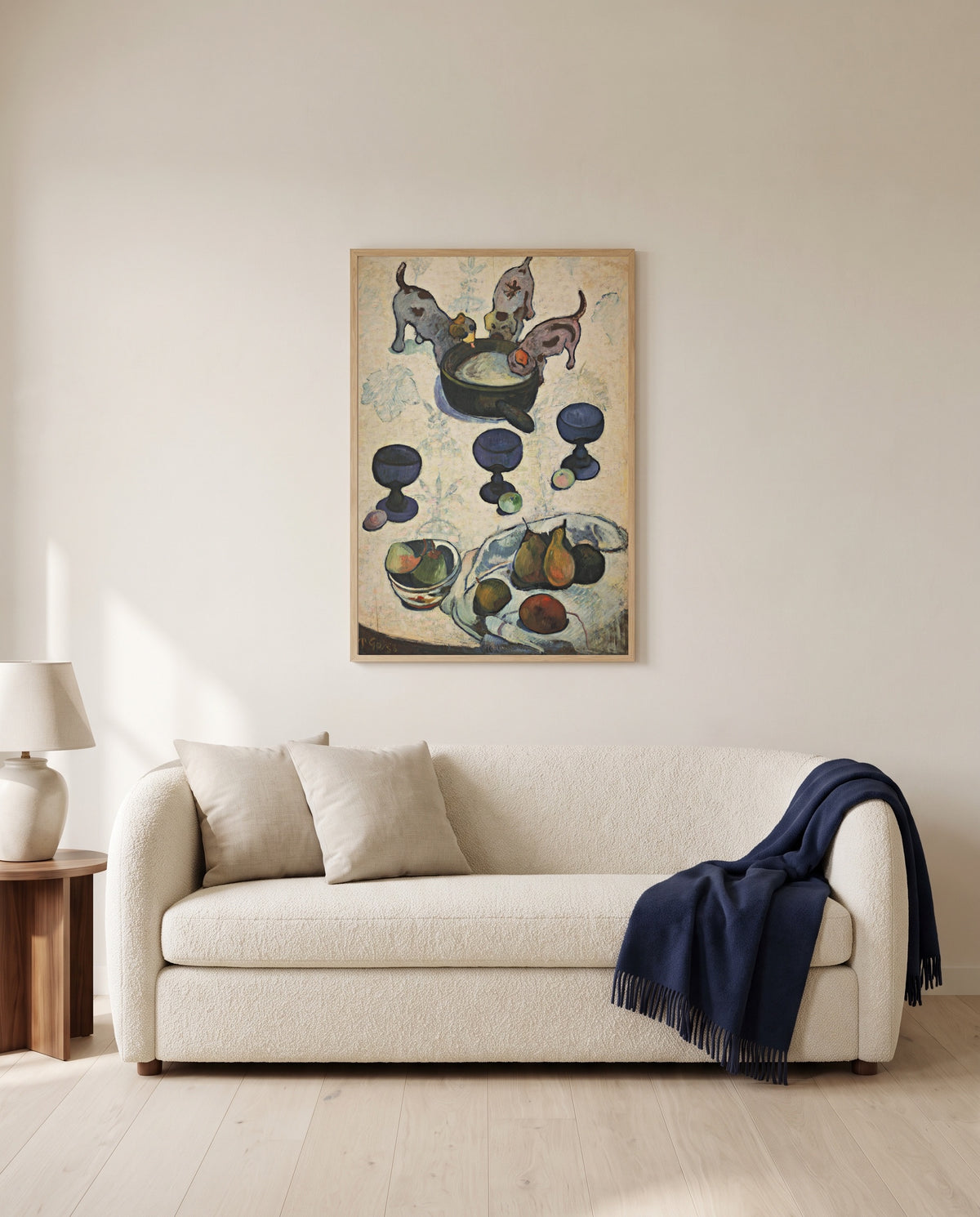 Three Puppies by Paul Gauguin framed in natural oak above a cream sofa in a warm living room