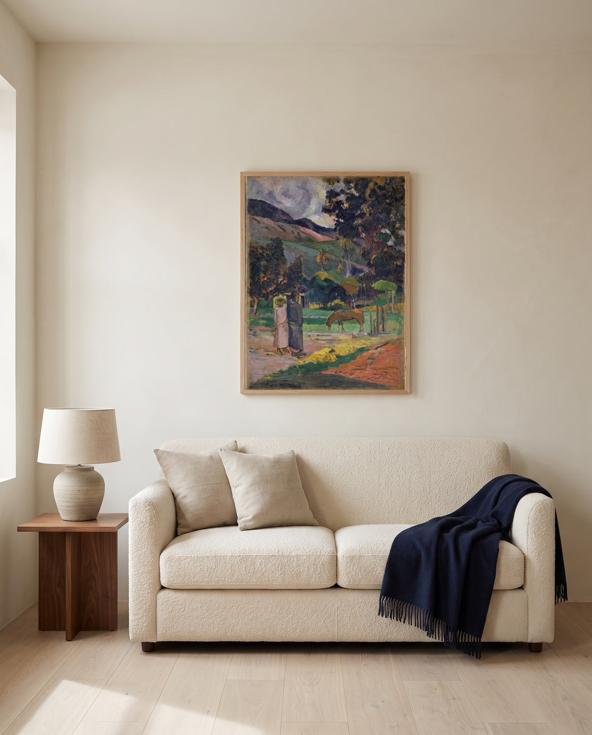 Tahitian Landscape, 1892 by Paul Gauguin framed in natural oak above a cream sofa in a warm living room