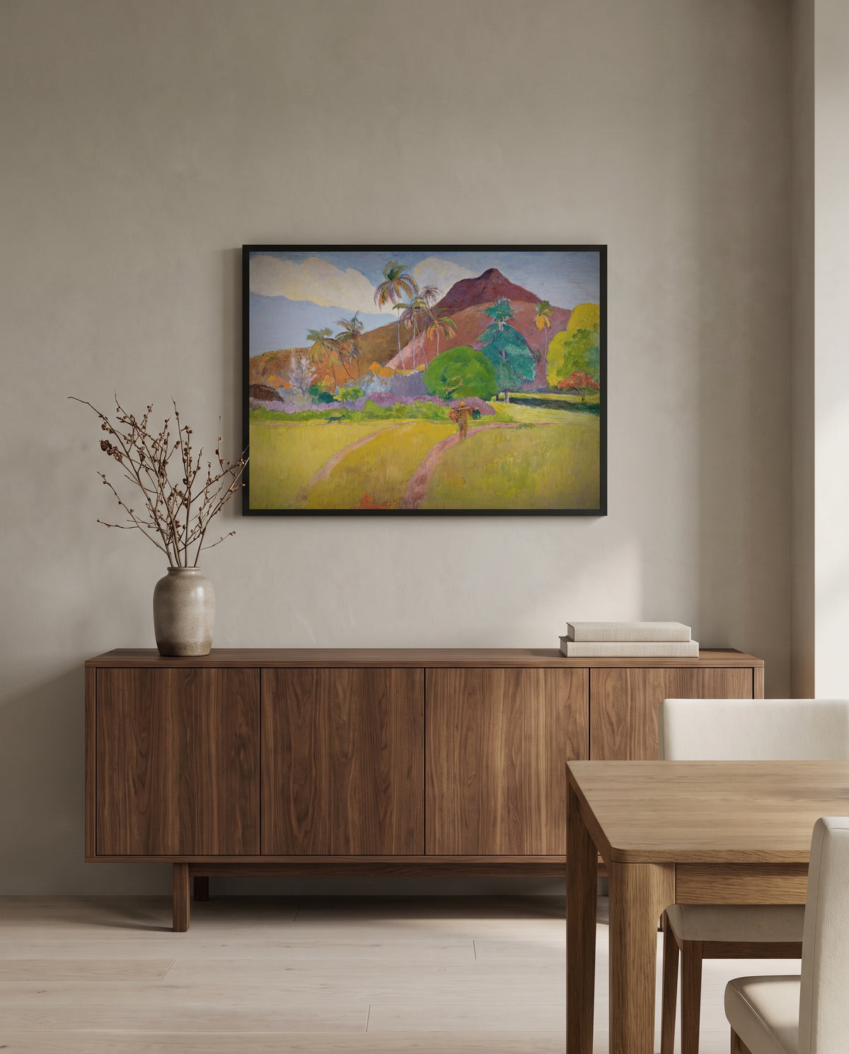 Tahitian Landscape by Paul Gauguin in a black frame above a walnut sideboard in a dining room