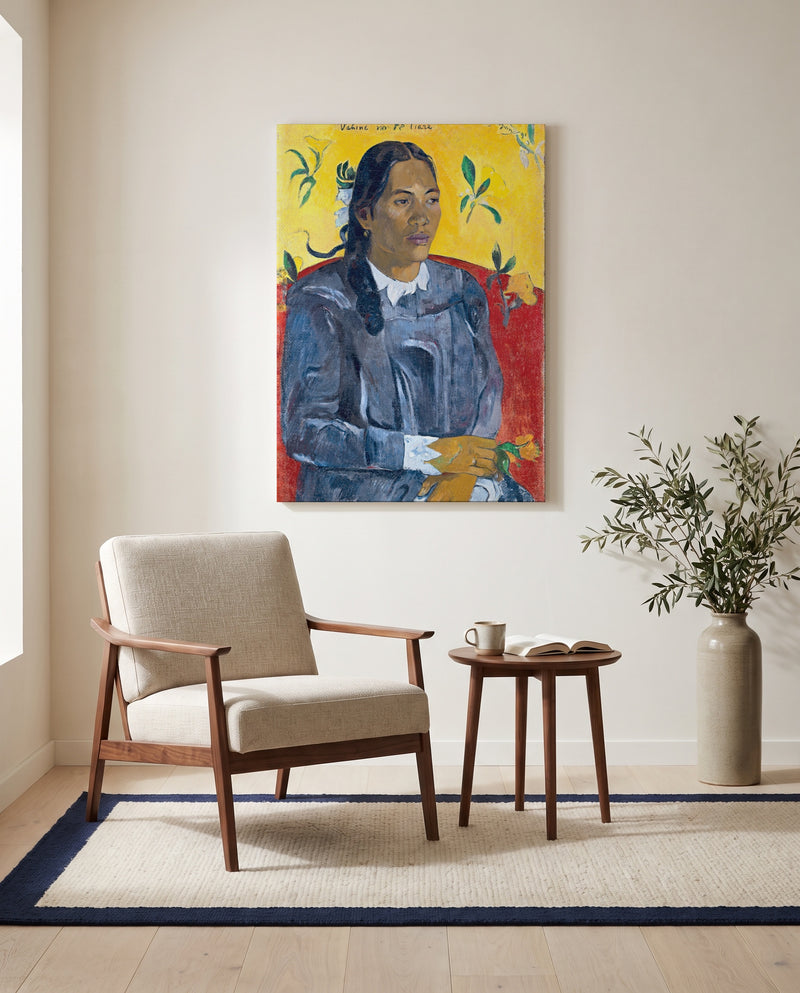 Woman with a Flower by Paul Gauguin as a stretched canvas above a linen lounge chair in a reading corner